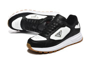 Angled view of black and white lace-up sneakers with perforated toe panels