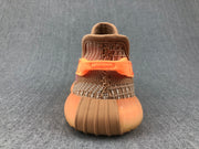 Rear view showing the orange heel detail, woven upper, and rounded ribbed outsole.
