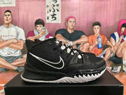 Side view of a black Nike basketball sneaker with a white Swoosh, textured upper, black midsole, and white tread.