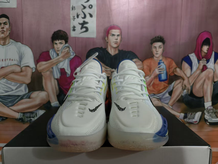 Front view of white Nike basketball shoes with blue and green accents