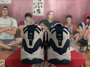 Rear view of navy and white Nike sneakers showing heel pull tabs
