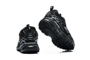Black sneakers viewed from the heel and outsole.