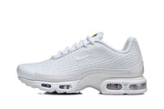 Side view of a white Nike Air Max Plus VI sneaker showing its textured upper and sole windows.