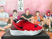 Side view of a red Nike basketball sneaker with black accents and a white outsole