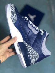 Side view showing the navy upper, elephant-print heel panel, and visible heel air unit.