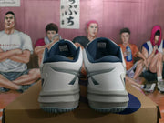 Rear view of white and navy ASICS Sky Elite FF shoes on a box, showing the padded collars, heel panels and outsole edges.