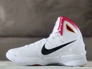 Angled side view showing the white shoe upper, lace-up front, perforations, and black Swoosh.