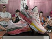 Angled view of the pair showing the side branding, sculpted sole, pink upper, and patterned outsole.