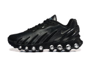 Side view of a black Nike Air Max DN sneaker with visible rounded sole pods