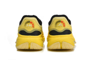 Rear view of the yellow shoes showing heel details and outsole