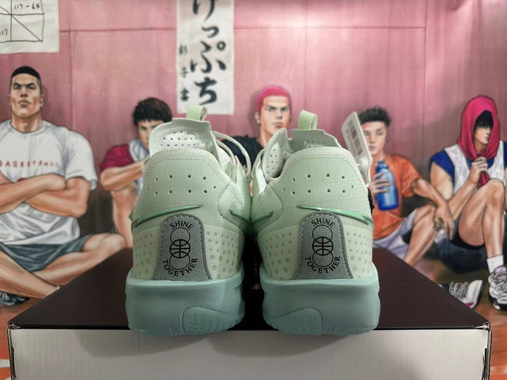 Rear view of pale green Nike G.T. Jump 2 basketball shoes showing heel details and perforations