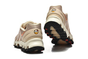 Rear and outsole views of beige Nike Air Max DN8 sneakers with orange accents