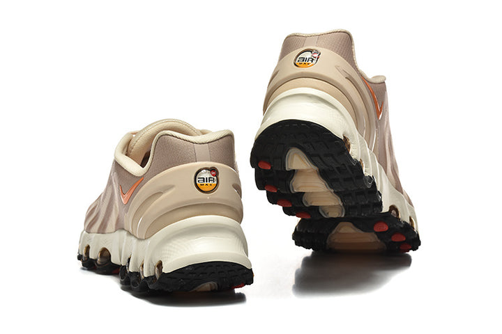 Rear and outsole views of beige Nike Air Max DN8 sneakers with orange accents