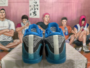 Rear view of gray and blue Nike basketball sneakers showing blue heel panels, gray uppers, and speckled blue outsoles.