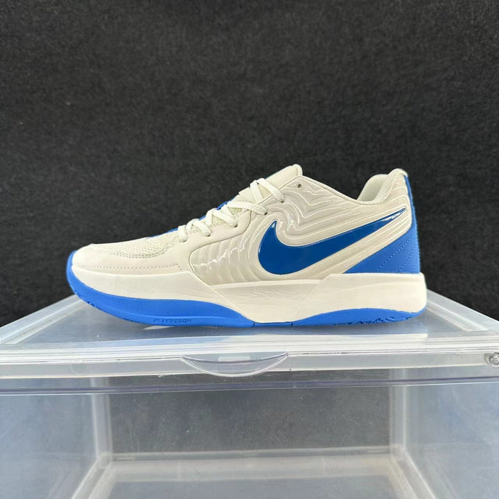 Side view of a cream-colored Nike low-top sneaker with a blue Swoosh and blue outsole accents.