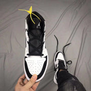 Top-down view of the sneaker showing the black tongue, laces, white perforated toe box, and Jordan tongue branding.