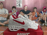 Side view highlighting the red Swoosh, white upper and red outsole details.
