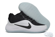 Black and white Nike Precision 8 shoe displayed beside its translucent outsole.