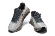 Front and top views of the gray On Cloudmonster 3 sneakers