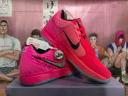 Pair of pink and red basketball shoes with black side logos and speckled detailing