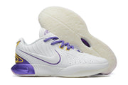 White Nike basketball shoes with purple and yellow accents.