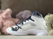 Side view of a white Nike Kobe basketball shoe with navy and gold details.