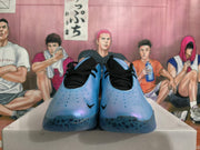 Front view of iridescent blue Nike basketball shoes with black laces and perforated toe areas