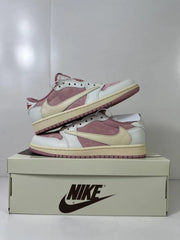 Side view of the paired sneakers showing cream Swoosh branding, pink panels, white overlays, and pink outsoles.