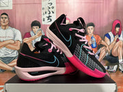 Pair of black Nike basketball shoes showing pink laces, teal details, and pink outsoles.