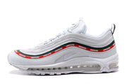 Side profile of a white Nike Air Max 97 sneaker with repeated UNDEFEATED wordmarks and visible Air cushioning.