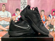 Black Nike sneakers arranged to show the lateral side, textured upper, laces and padded collar.