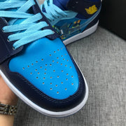 Close-up of a light-blue perforated toe box framed by navy overlays and stitching.