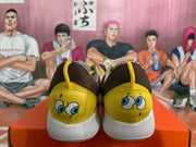 Rear view of yellow and white Nike sneakers showing SpongeBob artwork on both heels.