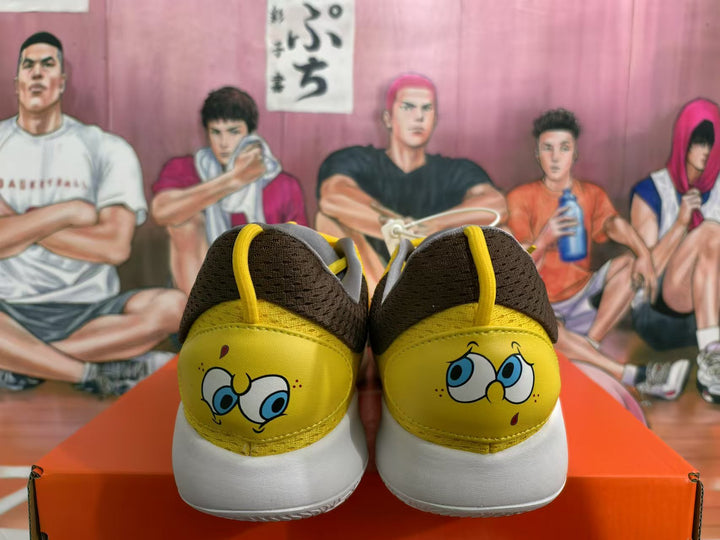 Rear view of yellow and white Nike sneakers showing SpongeBob artwork on both heels.