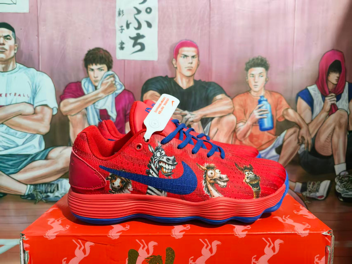 Side view of red and blue sneakers with illustrated character graphics, blue laces, and a visible Nike Swoosh.