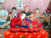 Side view of red and blue sneakers with illustrated character graphics, blue laces, and a visible Nike Swoosh.