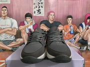 Front view of gray Nike sneakers with dark mesh uppers, tonal laces, black toe sections, and light midsoles.