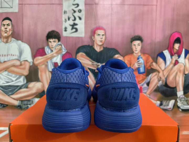 Rear view of blue Nike sneakers showing the padded collars, heel branding, and ribbed blue outsoles.