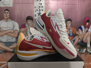 Angled view highlighting the red textured side panels, white Swoosh branding, and layered outsole.