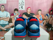 Rear view showing the blue heel panels, red collar accents, and printed heel details.