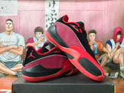 Pair of red and black Jordan basketball sneakers displayed on a black shoebox.