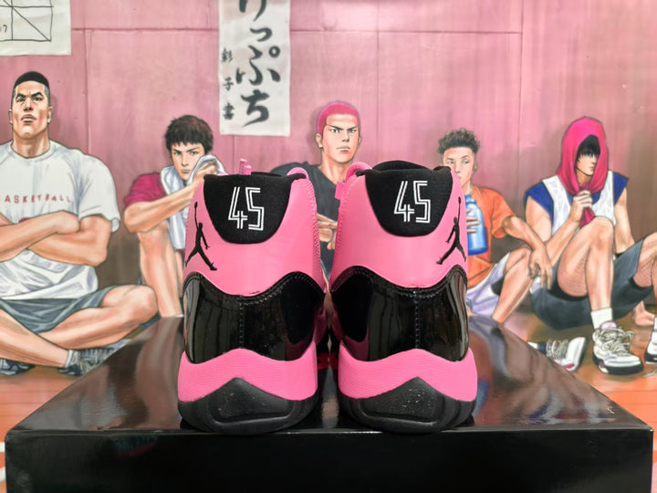 Rear view of pink and black high-top sneakers showing black heel panels, pink collars, and visible number 45 graphics.