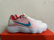 Side view of a Nike sneaker with pink patterned panels, a blue Swoosh, and a white ridged sole.