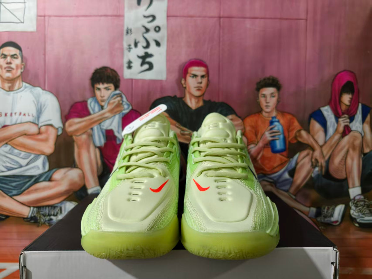 Front view of green Nike basketball shoes with pale green uppers, red swoosh details, and translucent green outsoles.