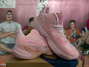 Angled view of pink ASICS basketball sneakers showing the layered side panels, raised branding and sculpted midsoles.