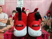 Rear view showing heel branding and pull tabs on red Nike basketball shoes