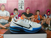Side view of a white basketball shoe with a black Nike Swoosh and blue sole.