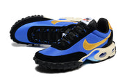 Angled view of the blue and black Nike sneakers with gold Swooshes and visible cushioning.
