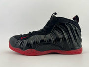 Black high-top sneaker with a red outsole and red swoosh.