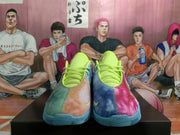 Front view of multicolor Nike basketball sneakers showing bright lime tongues and laces, blue and pink panels, and Nike Swoosh details.